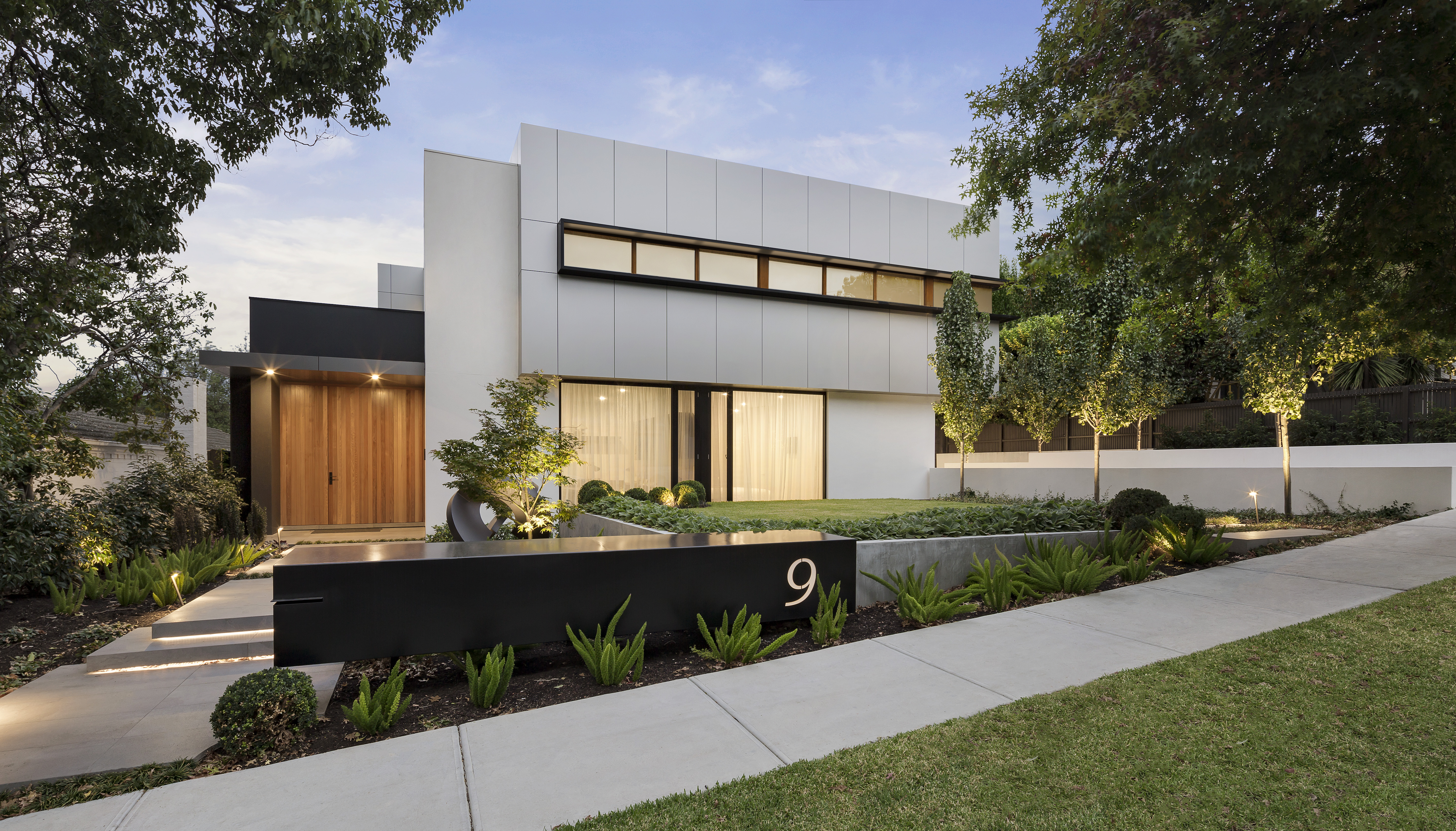 Bright white contemporary home with a landscaped exterior